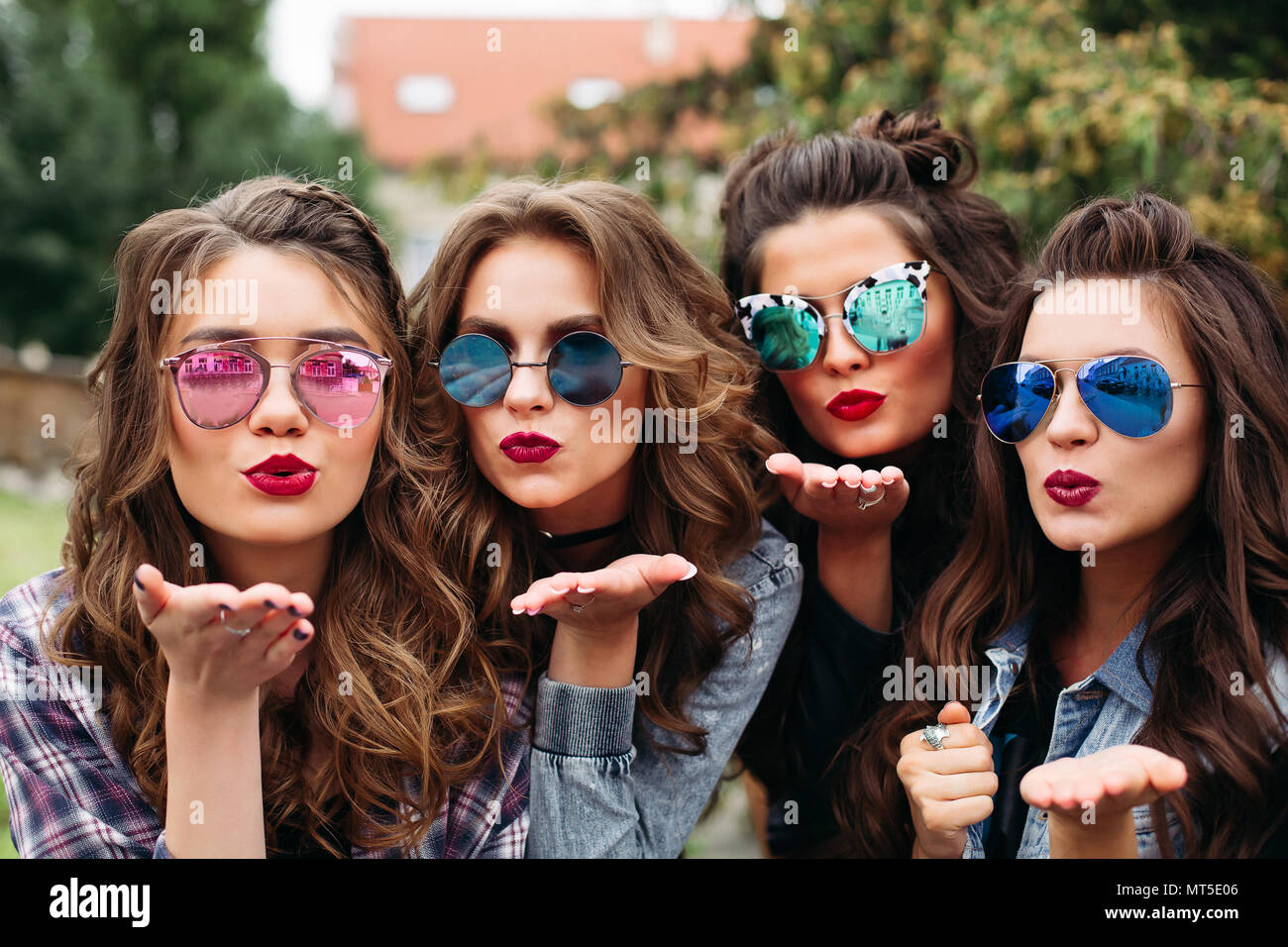 Fashionable ladies with hairstyle taking selfie outdoors. Stock Photo