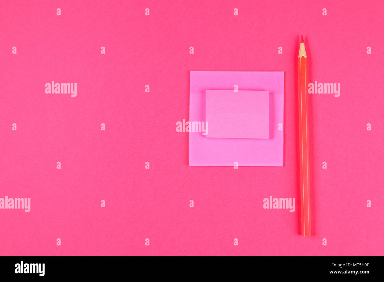 Pink felt-tip pen, pencil and sheets for notes on a pink pastel ...