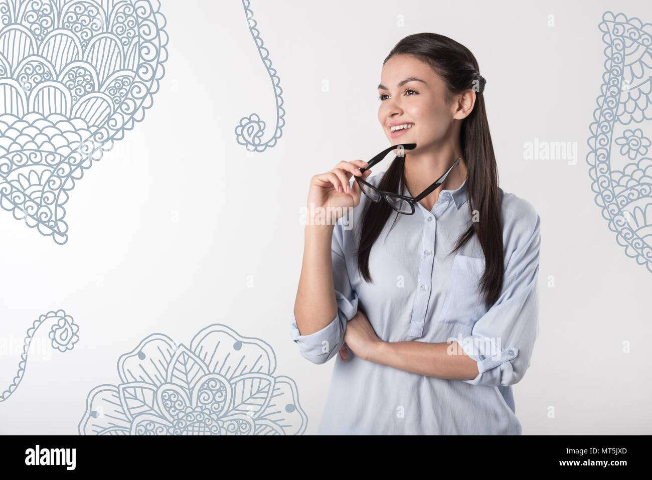 Relaxed teacher thoughtfully looking into the distance and smiling ...