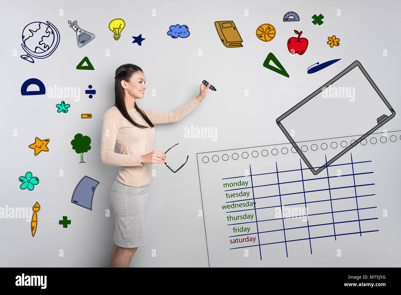 Emotional teacher smiling while writing on the blackboard Stock Photo ...