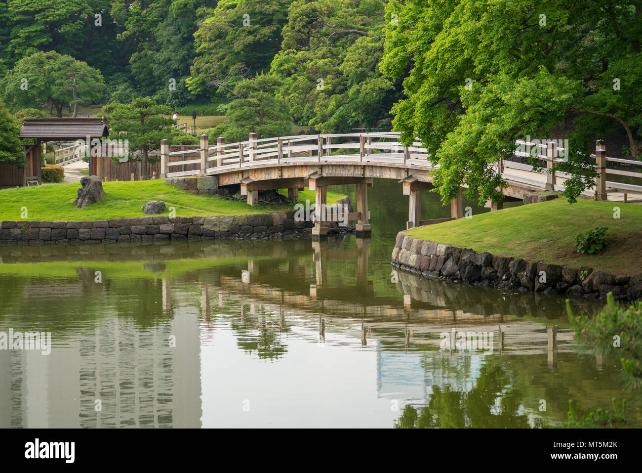 Hamarikyu Gardens in Tokyo are a popular spot for both tourists and locals.  This park has ponds, bridges and a Japanese tea house in its grounds. Stock Photo