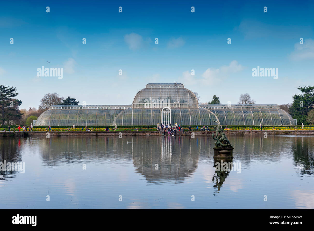 London, UK - April 2018: Palm House, an iconic Victorian glasshouse recreating a rainforest climate for tropical plants at Kew Garden, England Stock Photo