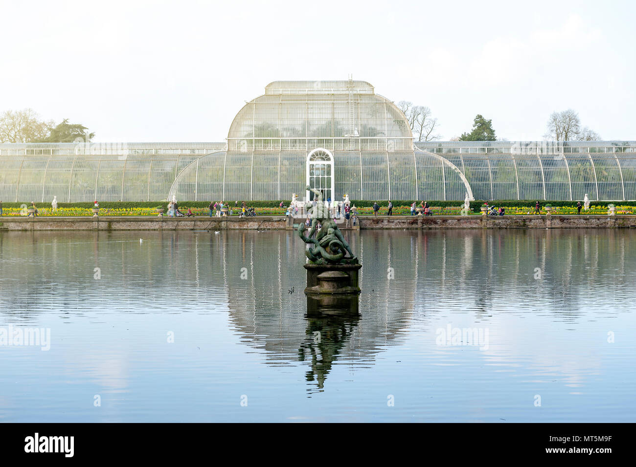 London, UK - April 2018: Palm House, an iconic Victorian glasshouse recreating a rainforest climate for tropical plants at Kew Garden, England Stock Photo