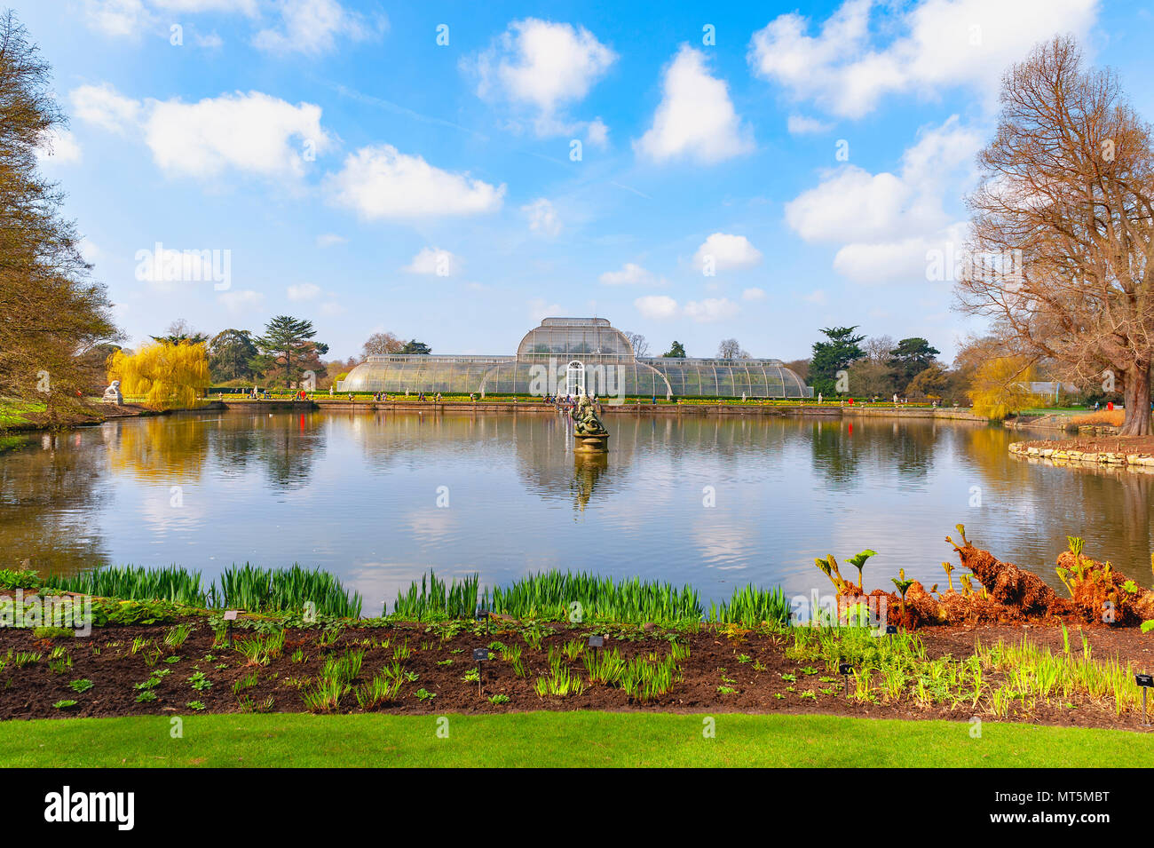 London, UK - April 2018: Palm House, an iconic Victorian glasshouse recreating a rainforest climate for tropical plants at Kew Garden, England Stock Photo