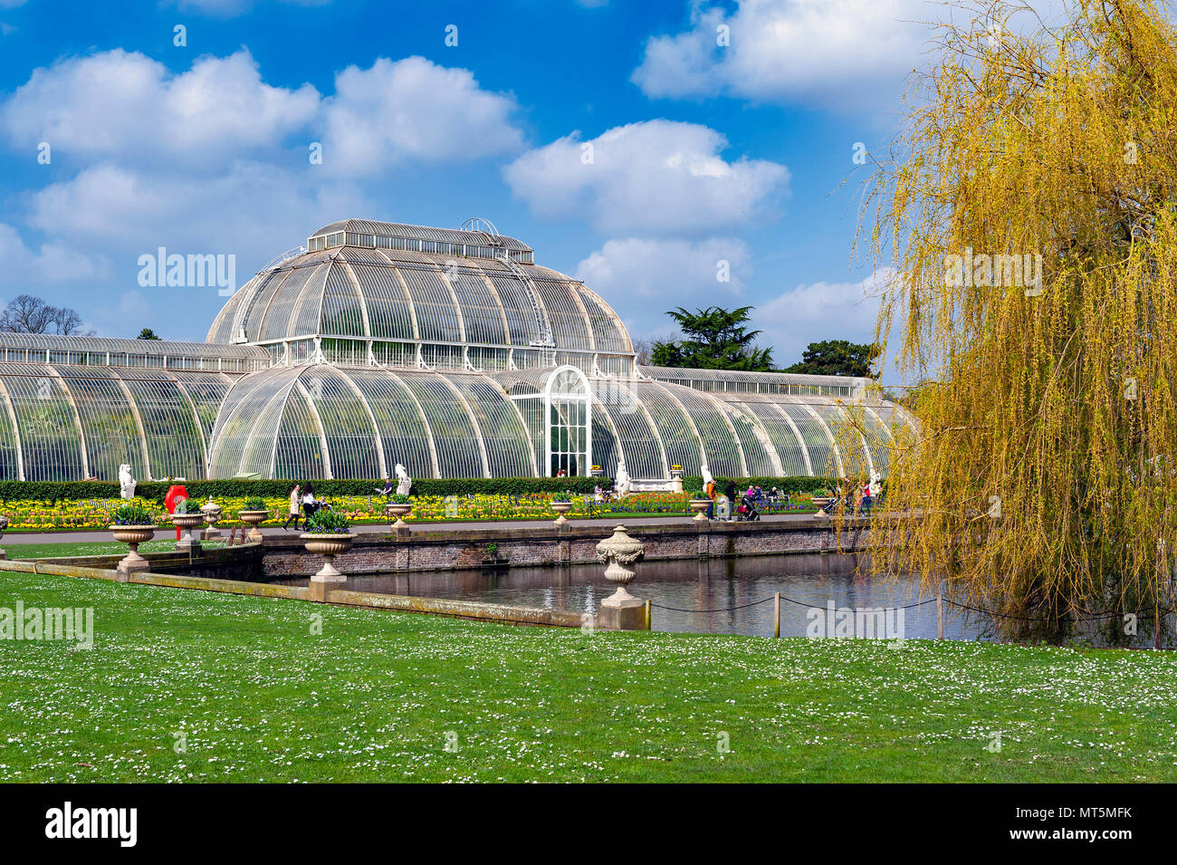 London, UK - April 2018: Palm House, an iconic Victorian glasshouse recreating a rainforest climate for tropical plants at Kew Garden, England Stock Photo