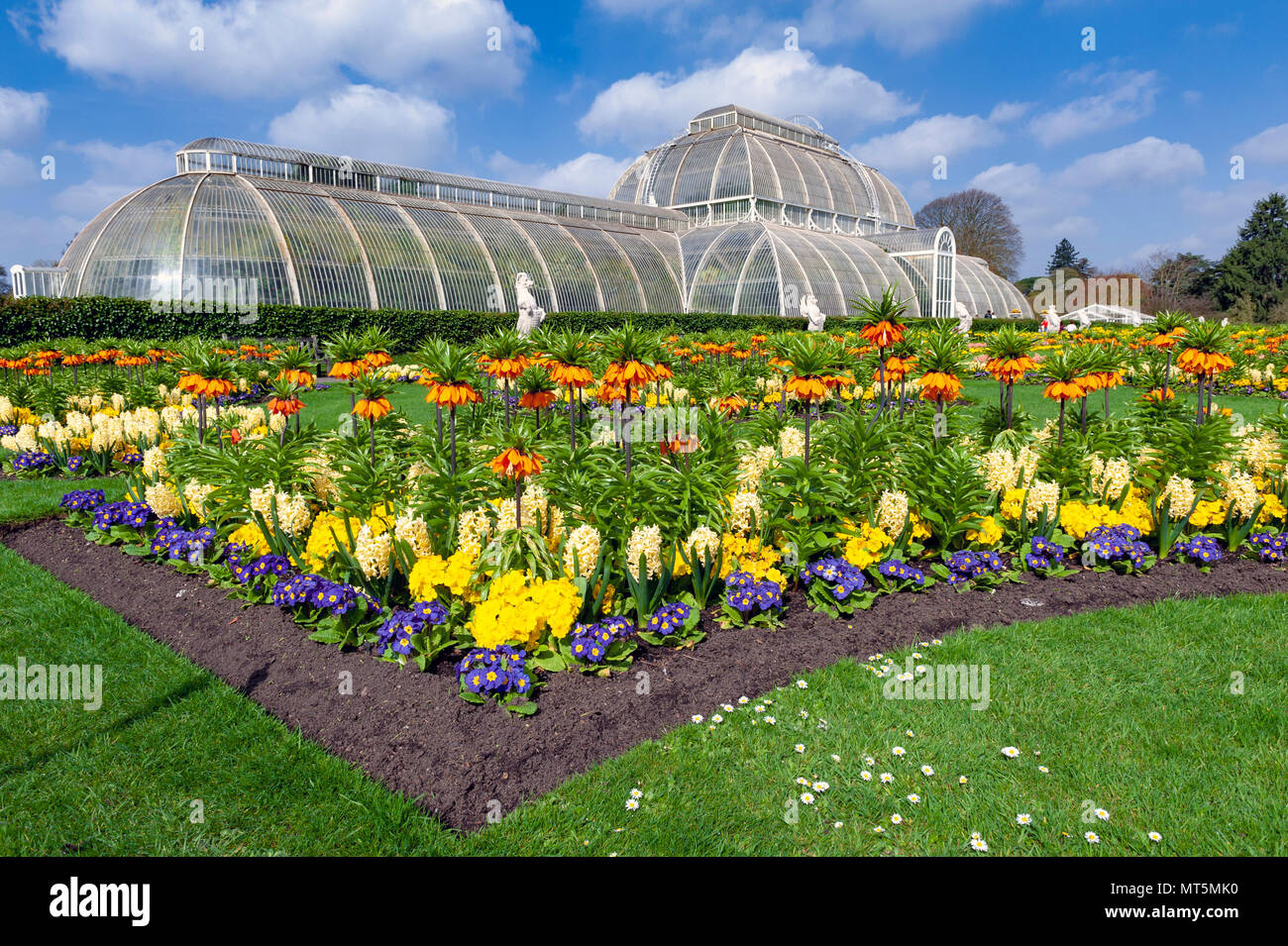 London, UK - April 2018: Palm House, an iconic Victorian glasshouse recreating a rainforest climate for tropical plants at Kew Garden, England Stock Photo