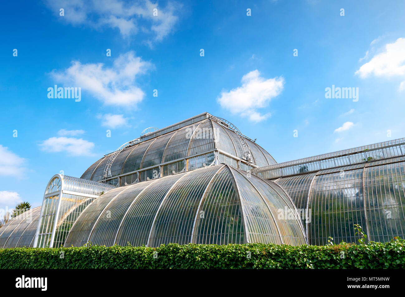 London, UK - April 2018: Palm House, an iconic Victorian glasshouse recreating a rainforest climate for tropical plants at Kew Garden, England Stock Photo