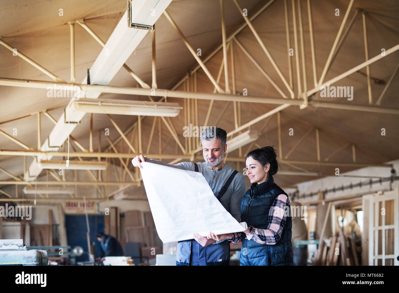 Man and woman workers in the carpentry workshop Stock Photo - Alamy