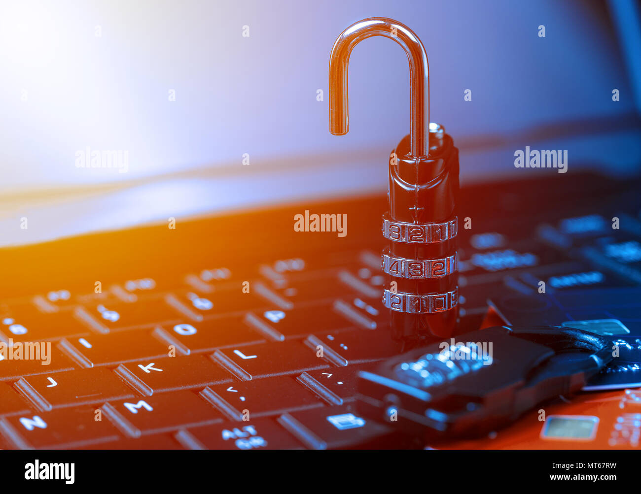 Online shopping concept with padlock open locked with cipher on laptop beside money cards. Non secure online shopping concept. Stock Photo