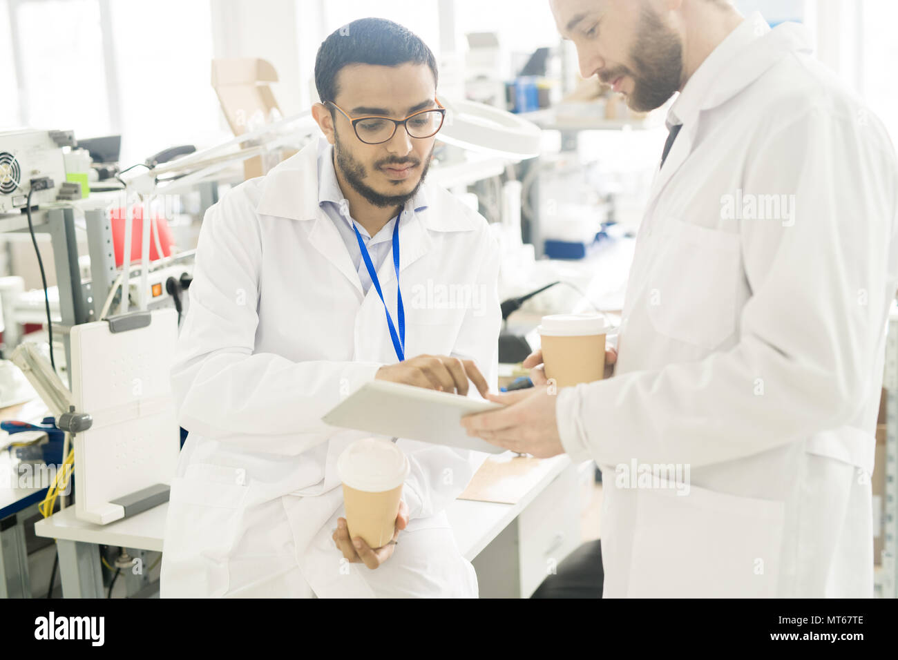 Serious engineers analyzing data on tablet Stock Photo