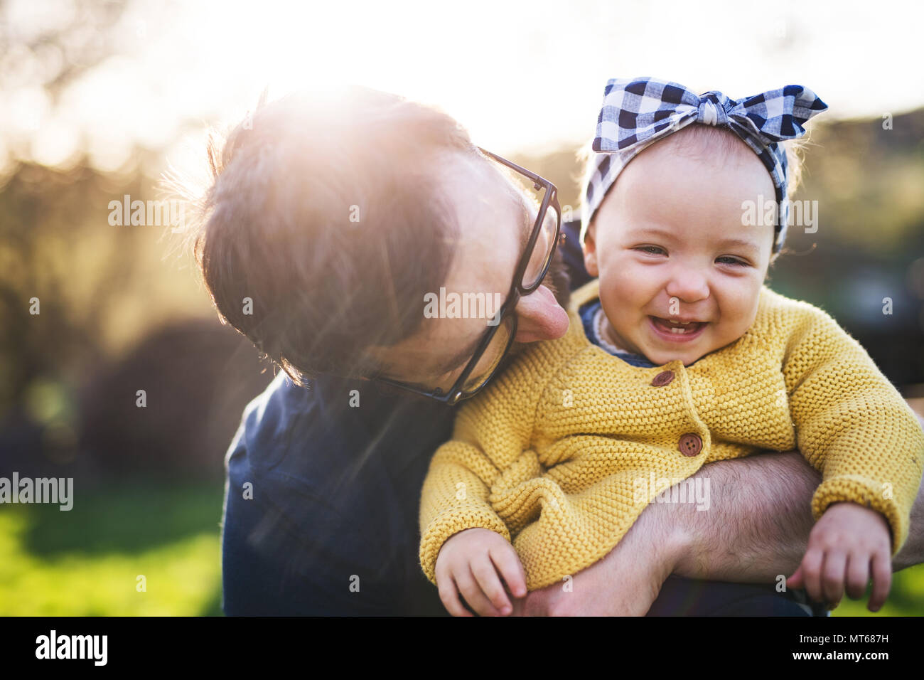 A father with his toddler daughter outside in spring nature. Stock Photo