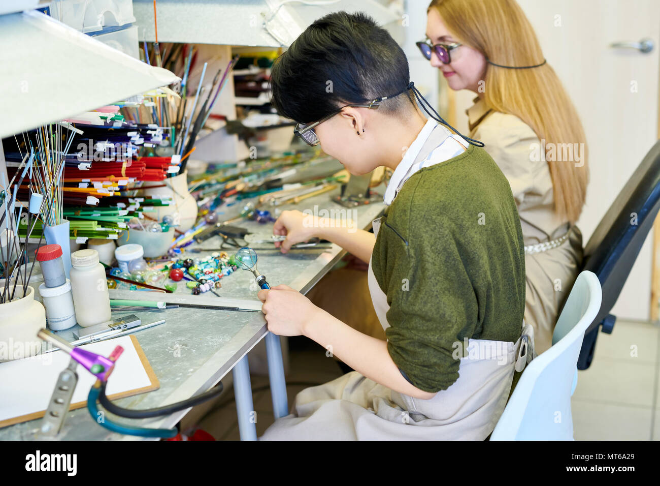 Two Female Artists Working in Glassworking Studio Stock Photo