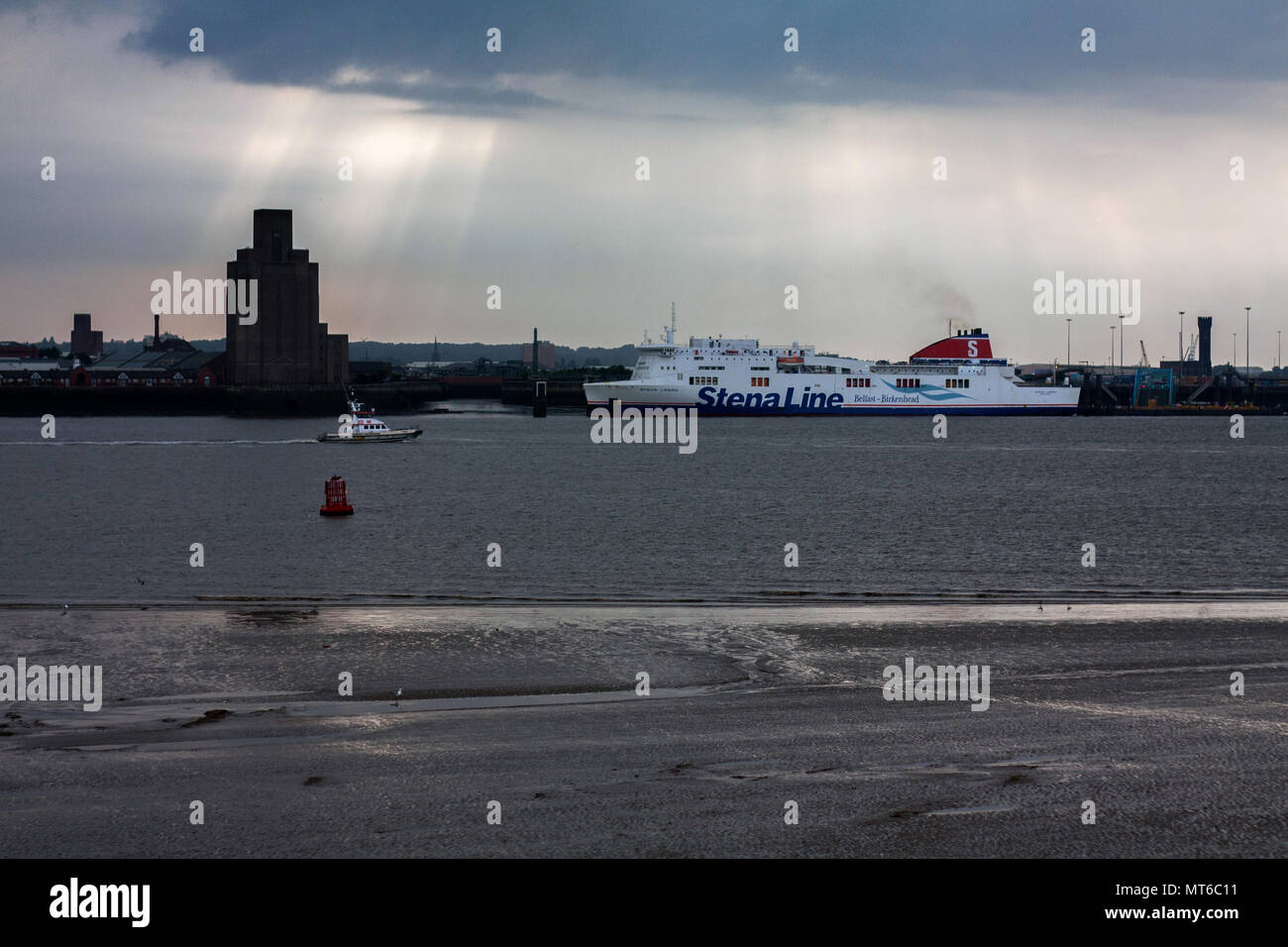 Sand shore of River Mersey in Liverpool, with a ship docked in Belfast, UK. Stock Photo