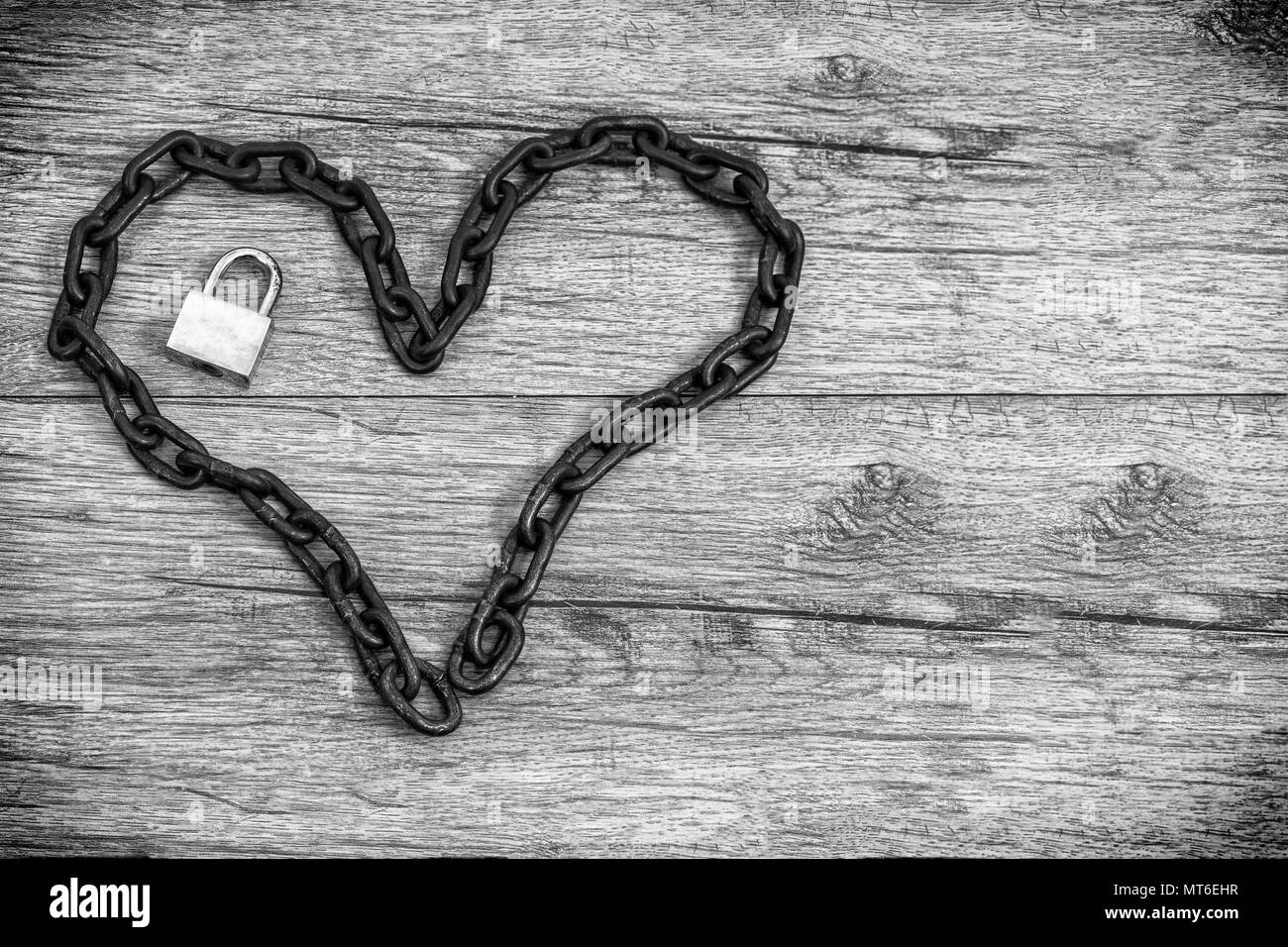 Chain heart shape with lock on wooden backround Stock Photo Alamy