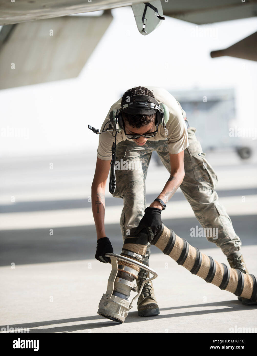 U.S Air Force Airman 1st Class Raven Quiles, an electrical and environmental  technician with the 763rd Expeditionary Aircraft Maintenance Unit, prepares  to attach the A/M32A-60B Generator Set to a RC-135V/W Rivet Joint