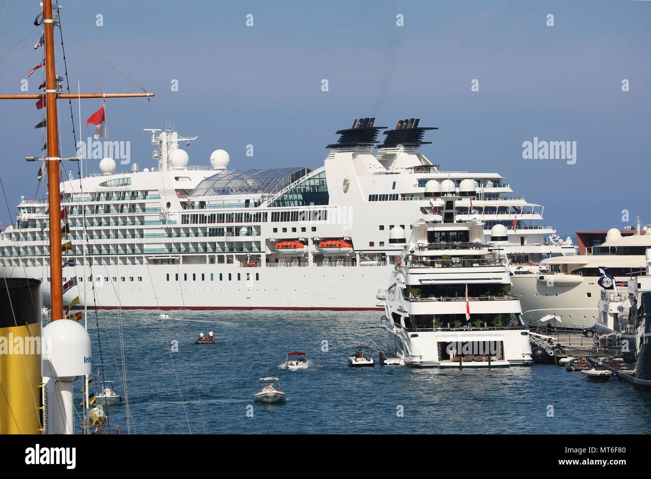 Monte-Carlo, Monaco - May 24, 2018: Rear View of a Luxury Superyacht In The Monte-Carlo Harbour (Port Hercule), Cruise Liner in The Background. Princi Stock Photo