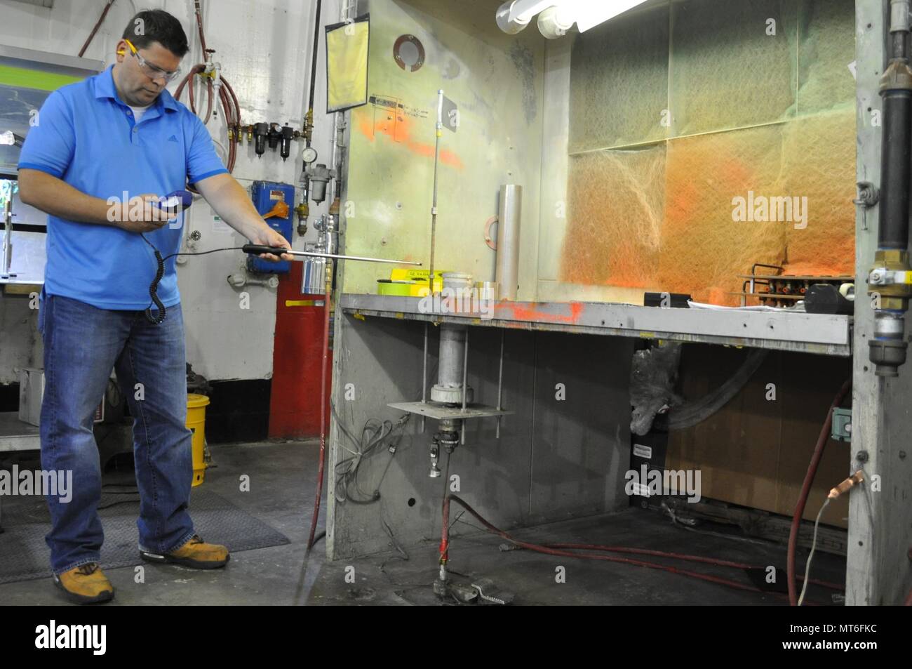A Crane Army industrial hygienist takes measurements of a ventilation