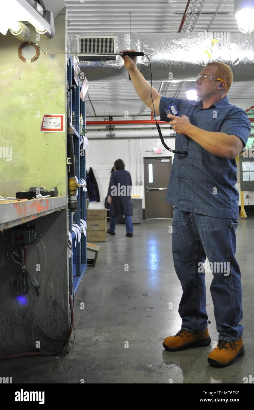 A Crane Army industrial hygienist takes measurements of a ventilation