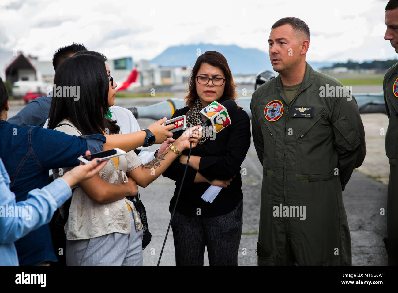 U.S. Marine Maj. Ryan E. Thompson, right, executive officer of the Aviation Combat Element, Special Purpose Marine Air-Ground Task Force - Southern Command, fields questions from local journalists during a media day at La Aurora International Airport in Guatemala City, Guatemala, July 31, 2017. At the invitation of the Guatemalan government, the Marines welcomed local media to tour two CH-53E’s, meet the crews and field questions with the commander of SPMAGTF-SC. The Marines and helicopters of the ACE will be based in Retalhuleu, Guatemala, for the next three weeks to better support the other  Stock Photo
