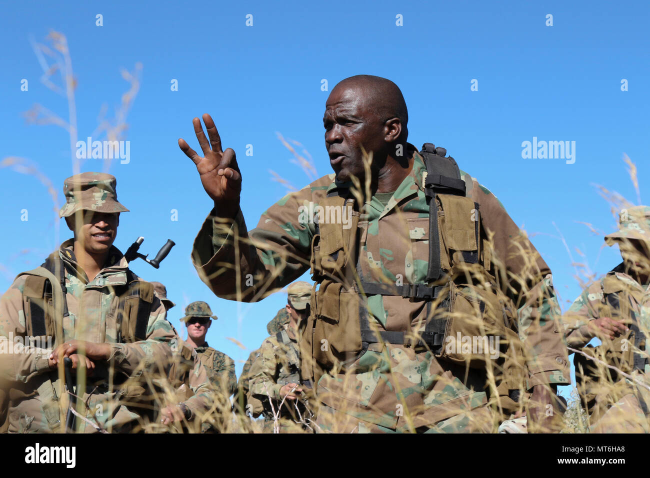 South African National Defense Force Staff Sgt. Moholo Matona, an infantry school instructor, instructs U.S. Marines from 3rd Battalion, 25th Marine Regiment and South African troops from the South African Navy, Maritime Reaction Squadron in bush terrain survival July 19, 2017, during Exercise Shared Accord 2017 at the South African Army Combat Training Center in Lohatla, South Africa. (U.S. Army photo by Sgt. 1st Class Alexandra Hays, 79th Sustainment Command (Support). Stock Photo