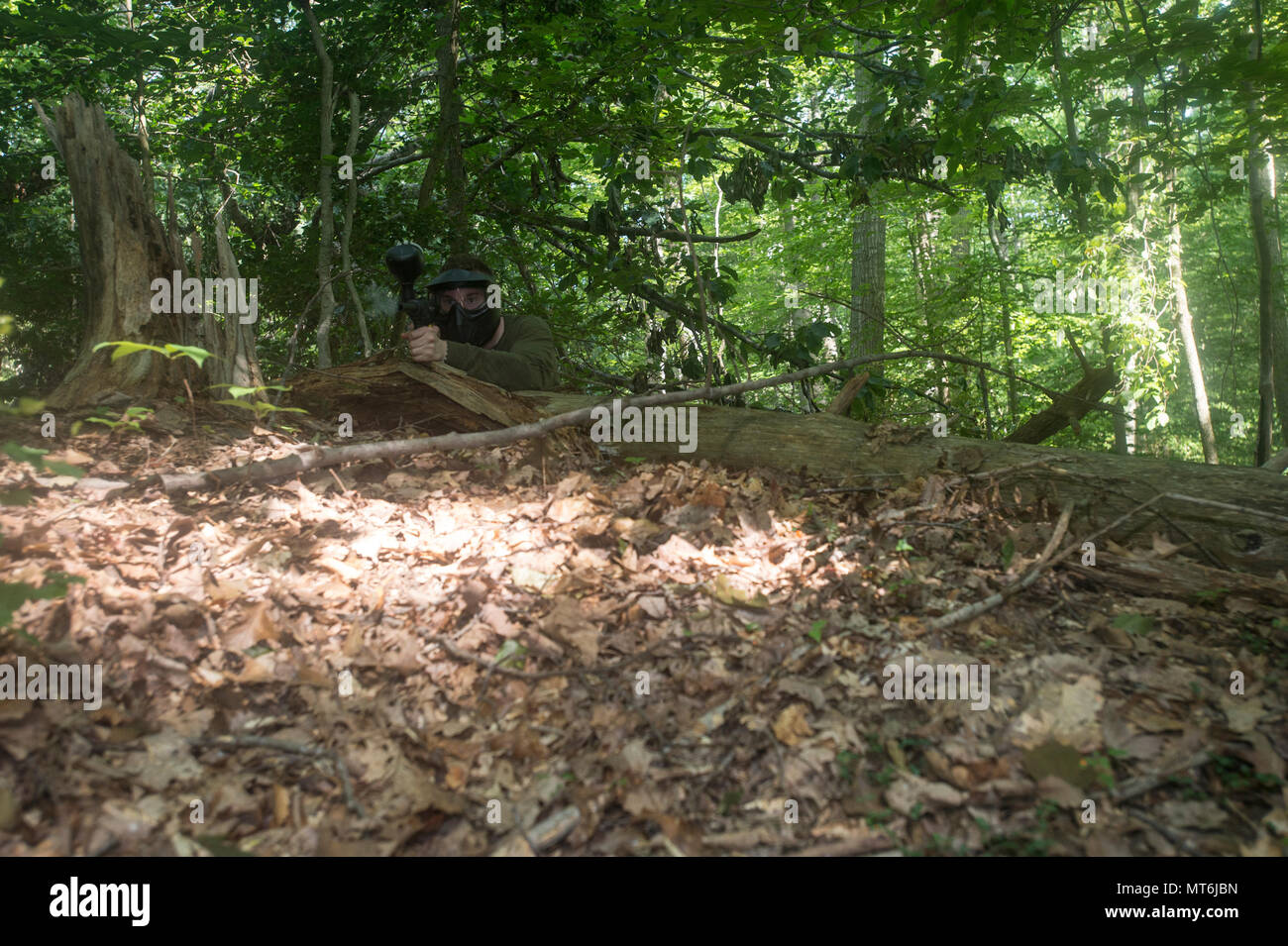 A participant fires his paintball gun during the Marine Corps Base