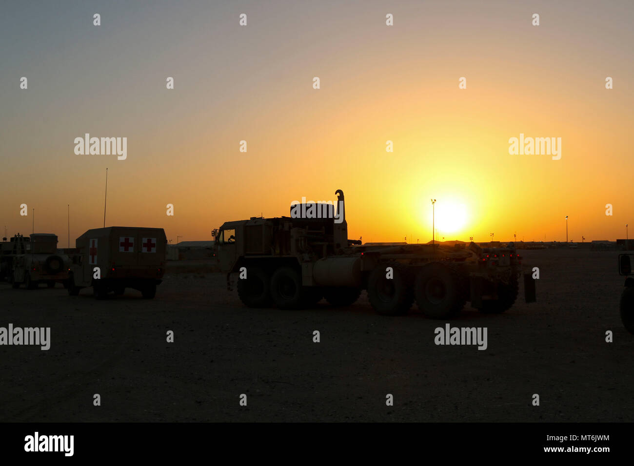 A line of vehicles from Alpha Company, 215th Brigade Support Battalion, 3rd Armored Brigade Combat Team, 1st Cavalry Division awaits the start of a convoy to a drop zone to conduct air drop resupply training July 27, 2017. For many of the Soldiers, this was their first time working with aircraft for a resupply mission. (U.S. Army photo by Staff Sgt. Leah R. Kilpatrick) Stock Photo