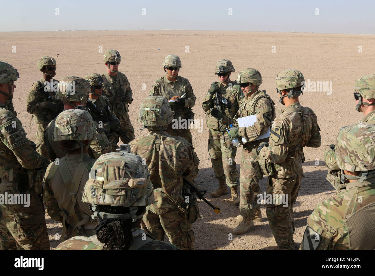 Capt. Tim Davis, the brigade aviation officer for the 3rd Armored Brigade Combat Team, 1st Cavalry Division, gives feedback to the Soldiers of the 215th Brigade Support Battalion, 3rd ABCT, 1st Cav. Div. after the completion of air drop resupply training. The Soldiers executed a tactical convoy to the drop zone, established drop zone security, set up and marked the drop zone, and recovered the resupply. (U.S. Army photo by Staff Sgt. Leah R. Kilpatrick) Stock Photo