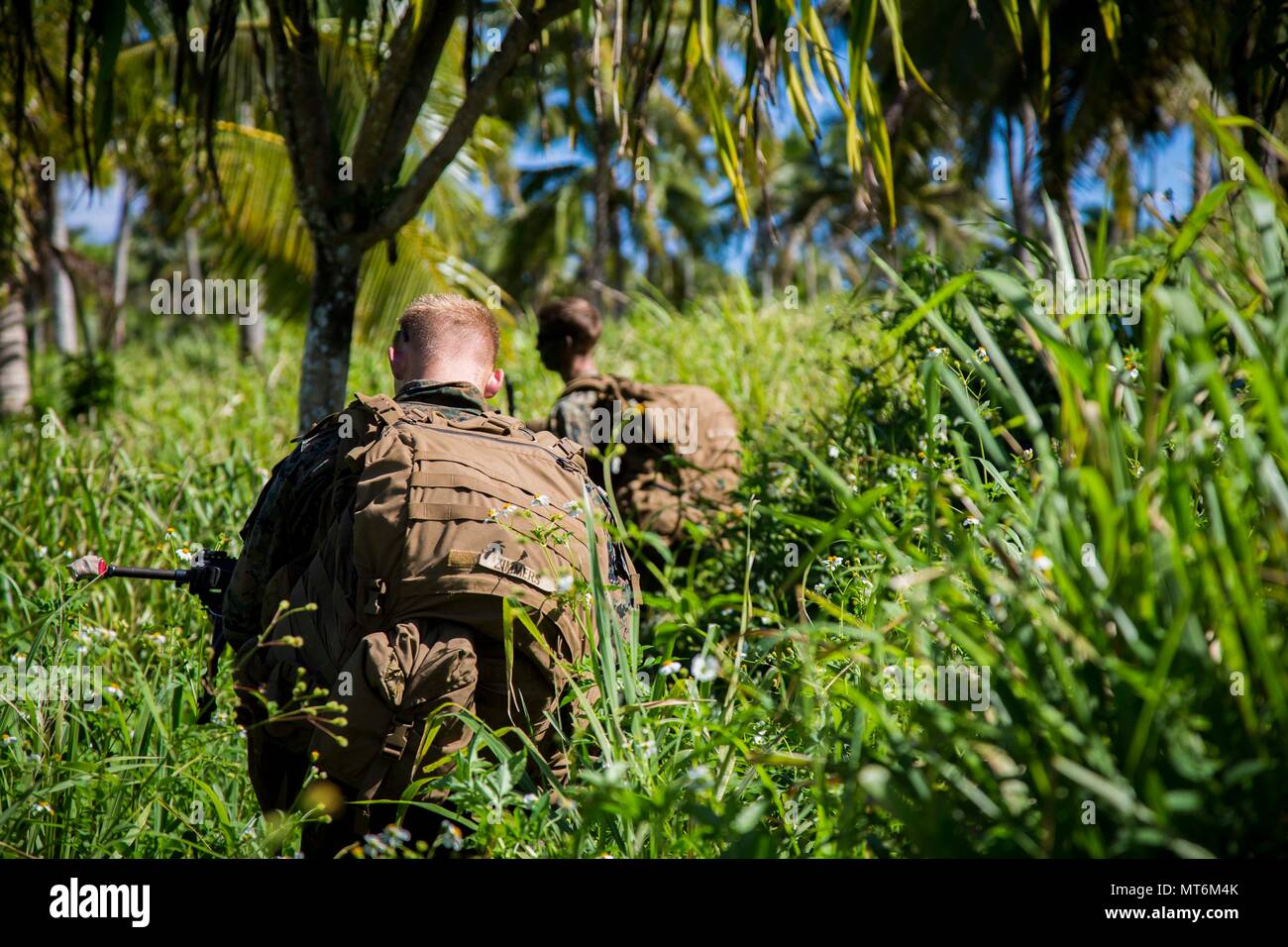 U.S. Marines with 3rd Battalion 4th Marines attached to Task Force Koa Moana 17, move to an objective during a joint service infantry training exercise as a part of Exercise TAFAKULA on Vava’u Island, Tonga, July 25, 2017. Exercise TAFAKULA is designed to strengthen the military-to-military, and community relations between Tonga’s His Majesty’s Armed Forces, French Army of New Caledonia, New Zealand Defense Force, and the United States Armed Forces.  (U.S. Marine Corps photo by MCIPAC Combat Camera Lance Cpl. Juan C. Bustos) Stock Photo