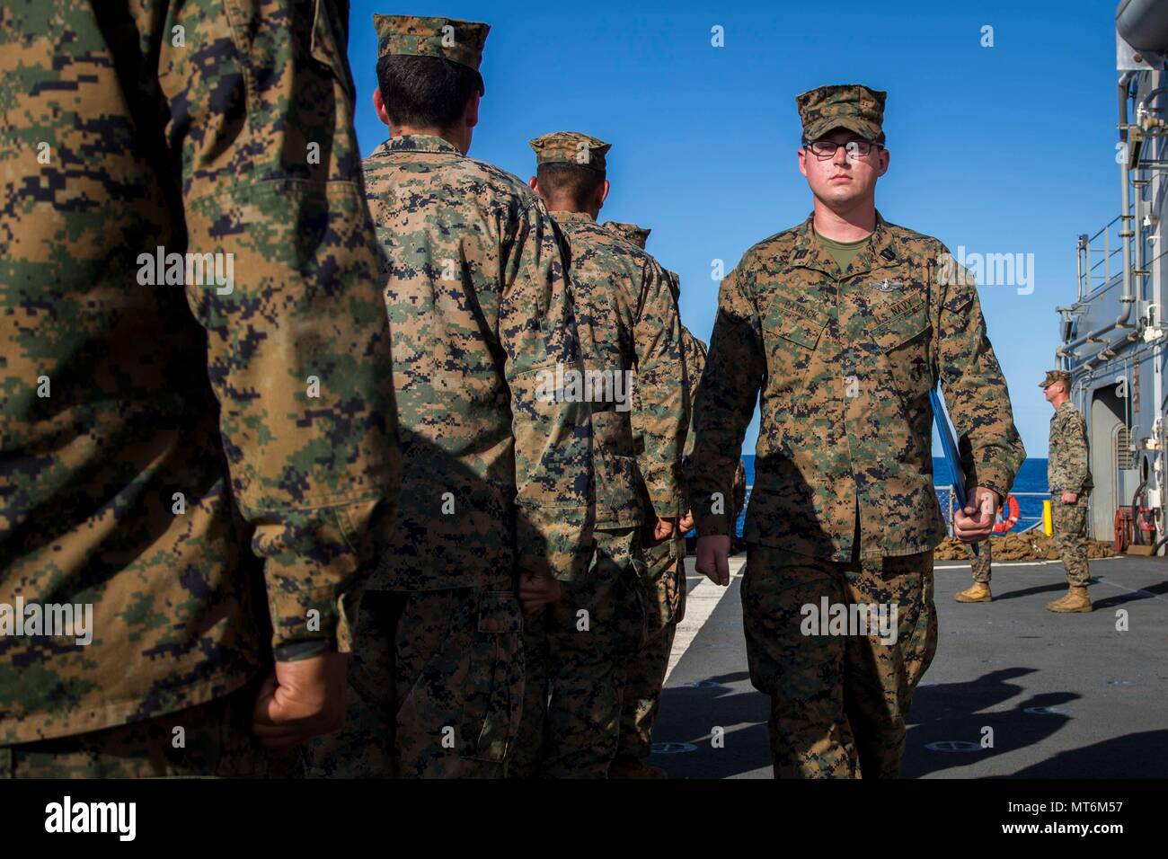 Navy Seaman Charles Patrick, a hospital man attached to Task Force Koa Moana 17 marches after receiving his Enlisted Fleet Marine Force Warfare Specialist Insignia (FMF) award on the USNS Sacagawea, July 28, 2017. The FMF award is given to Navy enlisted personnel who are attached to deployable U.S. Marine Corps units and pass verbal and written exams qualifying the individual adept in Marine Corps history, and knowledge.   (U.S. Marine Corps photo by MCIPAC Combat Camera Lance Cpl. Juan C. Bustos) Stock Photo