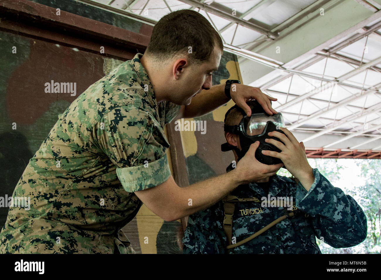 U.S. Marine Corps Sgt. Chris Mantakounis, left, a chemical ...