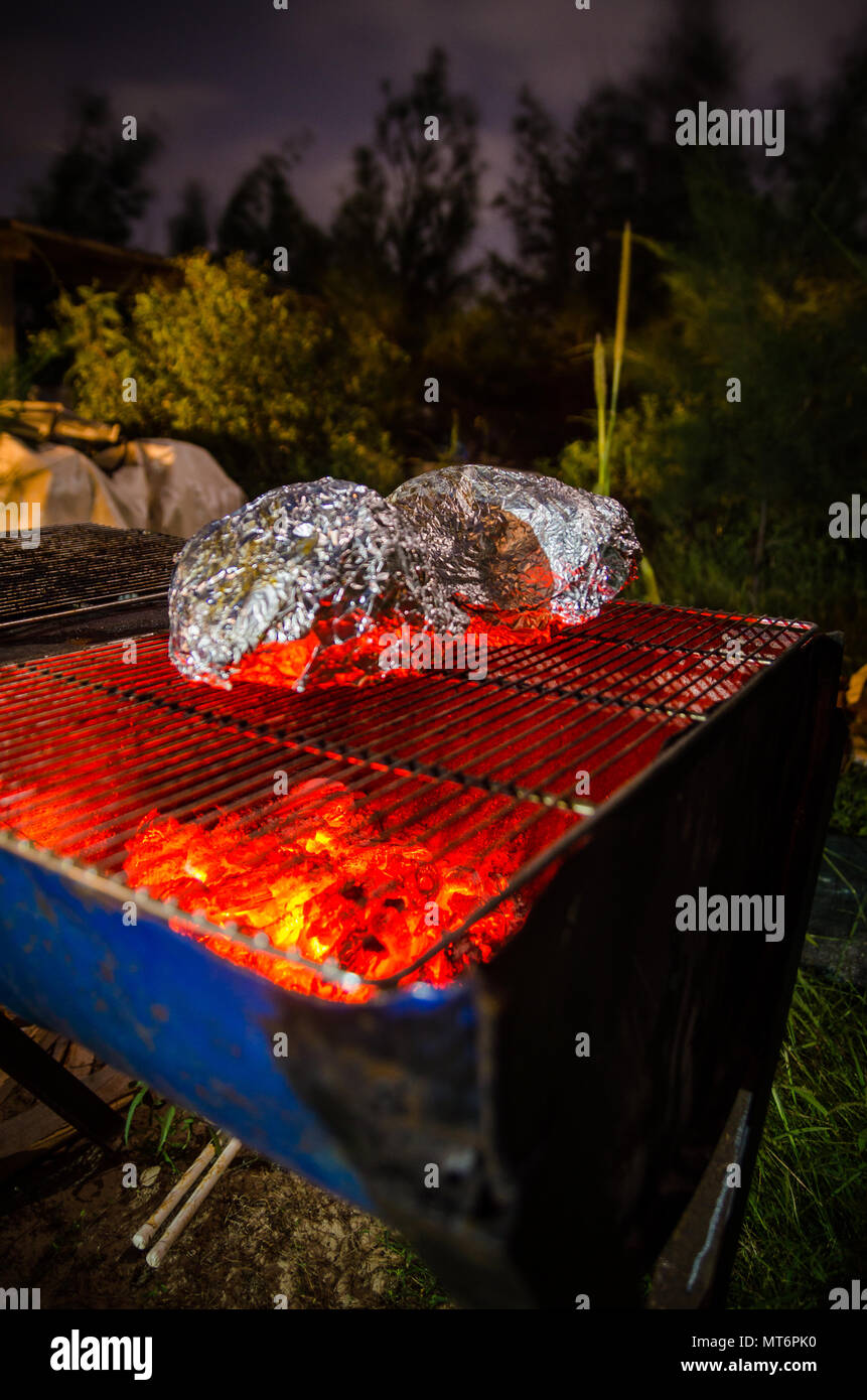 https://c8.alamy.com/comp/MT6PK0/closeup-of-glowing-ambers-in-barbecue-barrel-grilling-meat-wrapped-in-aluminium-foil-during-the-night-MT6PK0.jpg