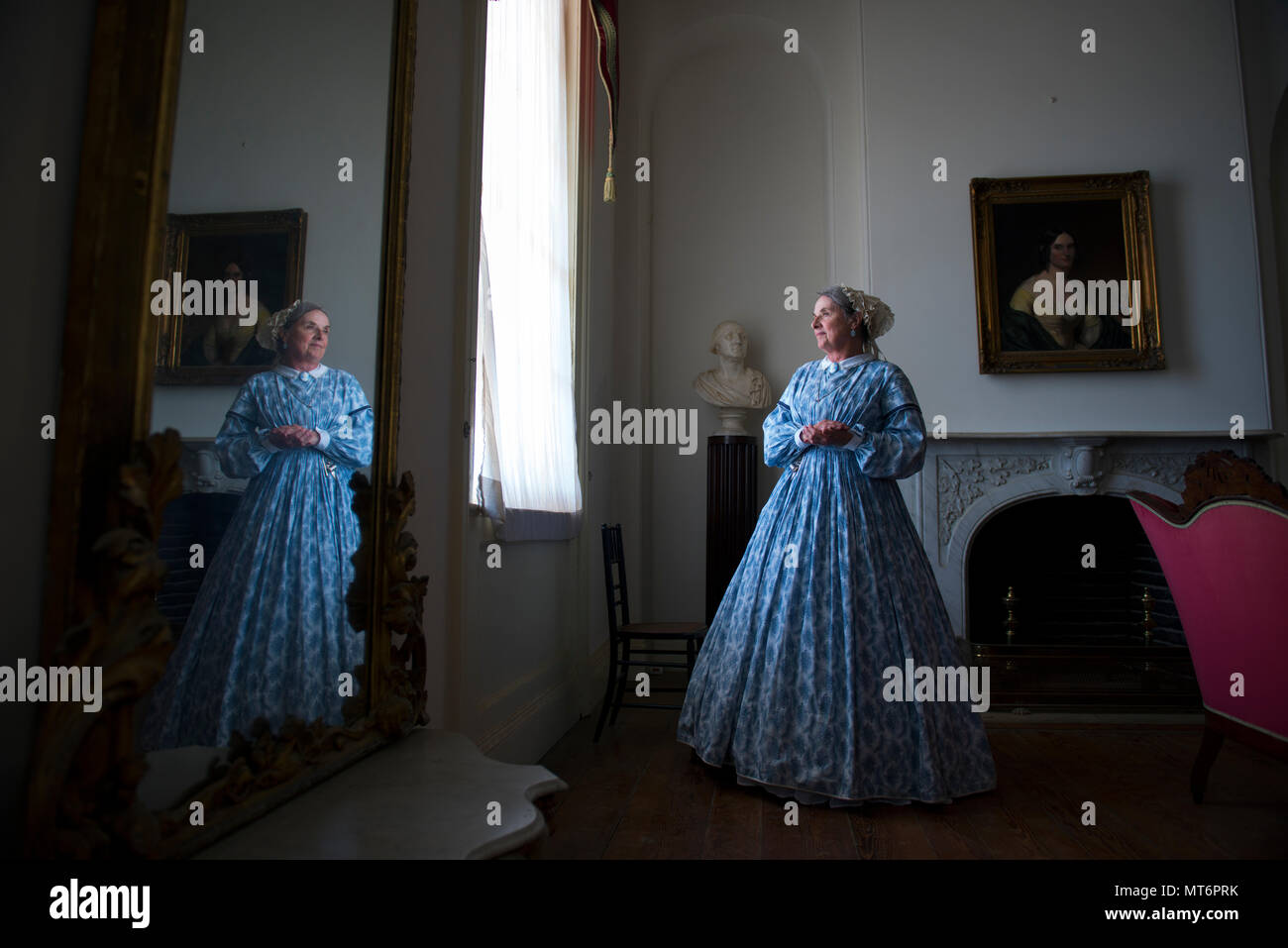 Docent volunteer, Roberta 'Bobbie' Jones, stands in the White Parlor room of the Arlington House, a Robert E. Lee Memorial, in Arlington National Cemetery, Arlington, Va., July 19, 2017.  In July of 2015, philanthropist David M. Rubinstein announced a $12.35 million donation to the National Park Foundation’s Centennial Campaign for America’s National Parks to restore and improve access to Arlington House.  This work is scheduled to begin in late August 2017, limiting access to visitors.  (U.S. Army photo by Elizabeth Fraser / Arlington National Cemetery / released) Stock Photo