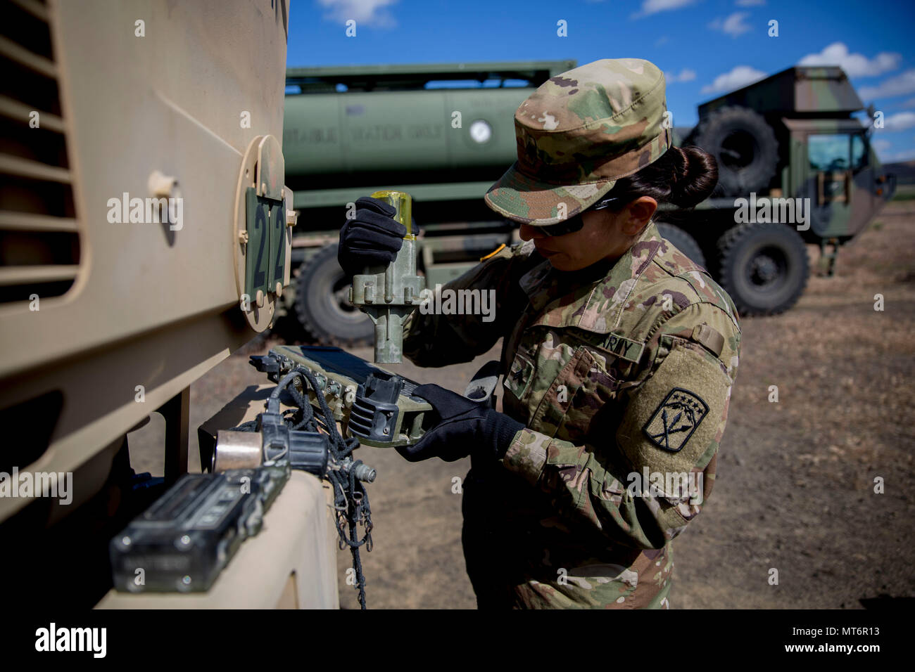 A U.S. Army Soldier installs multiple integrated laser engagement