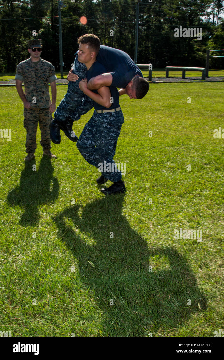 U.S. Naval ROTC Midshipman Collin Pounds, center, Rensselaer ...