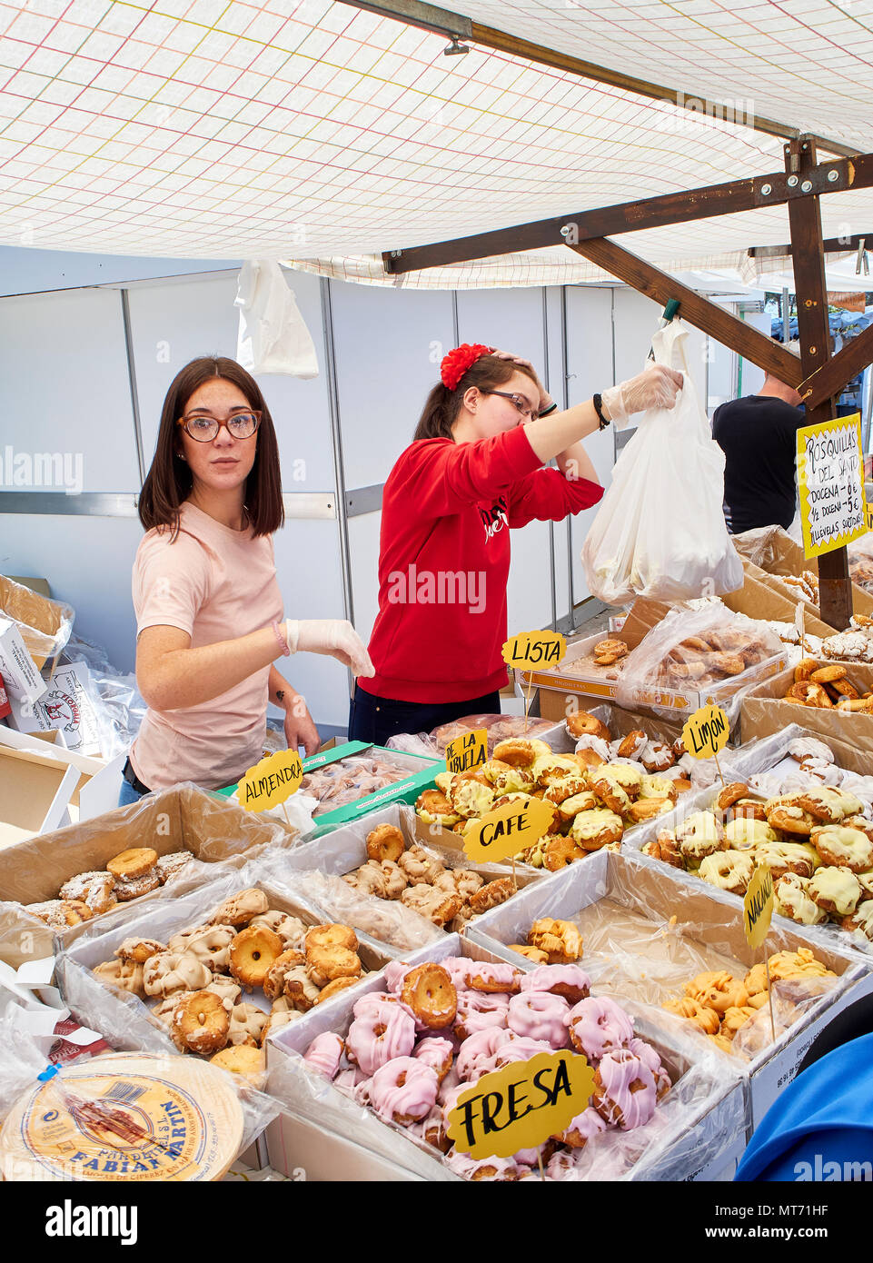 Bakers selling Rosquillas del Santo, typical Spanish sweet, in a bakery