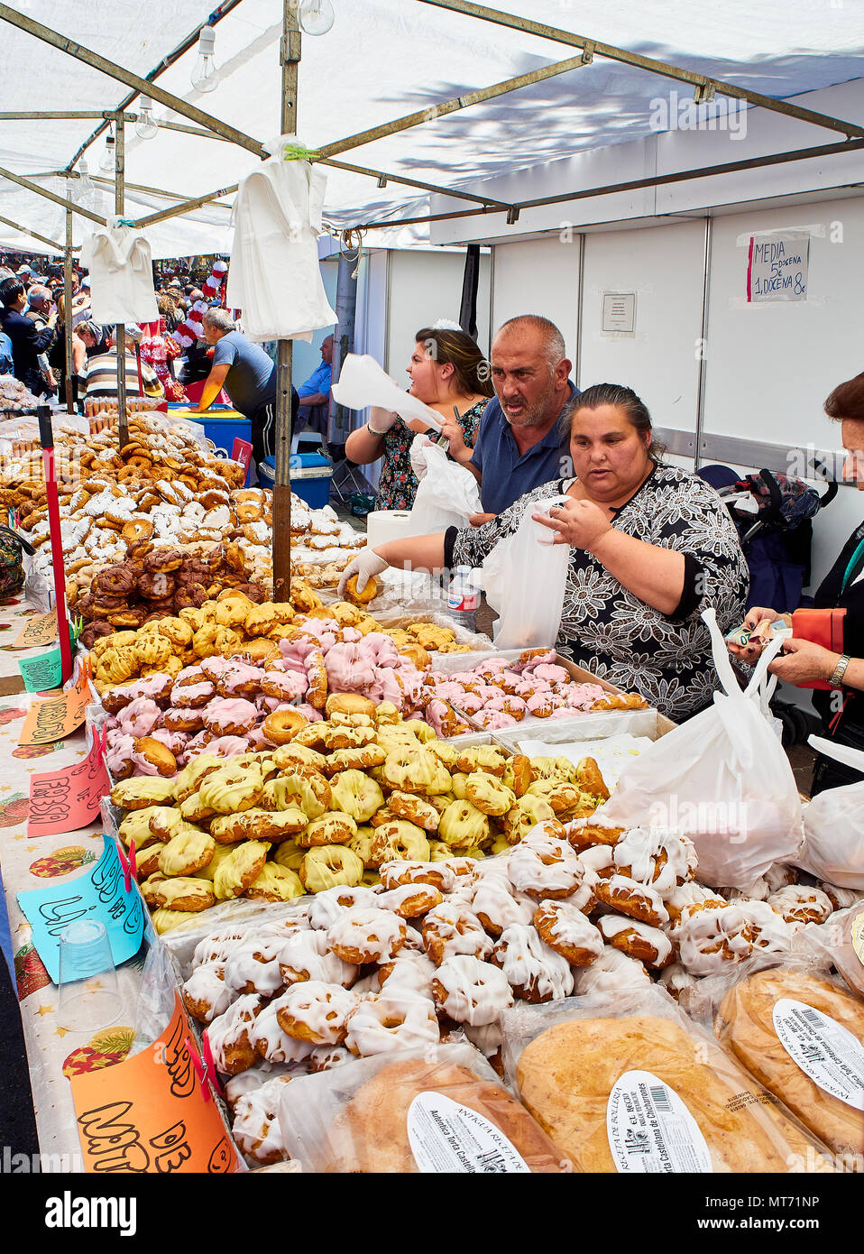 Bakers selling Rosquillas del Santo, typical Spanish sweet, in a bakery