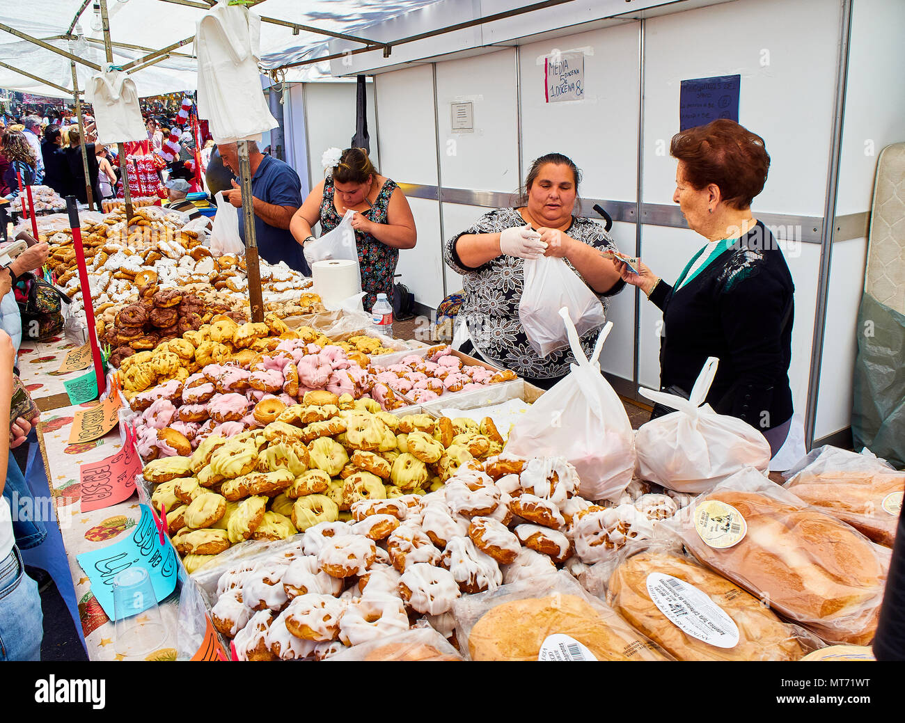 Bakers selling Rosquillas del Santo, typical Spanish sweet, in a bakery