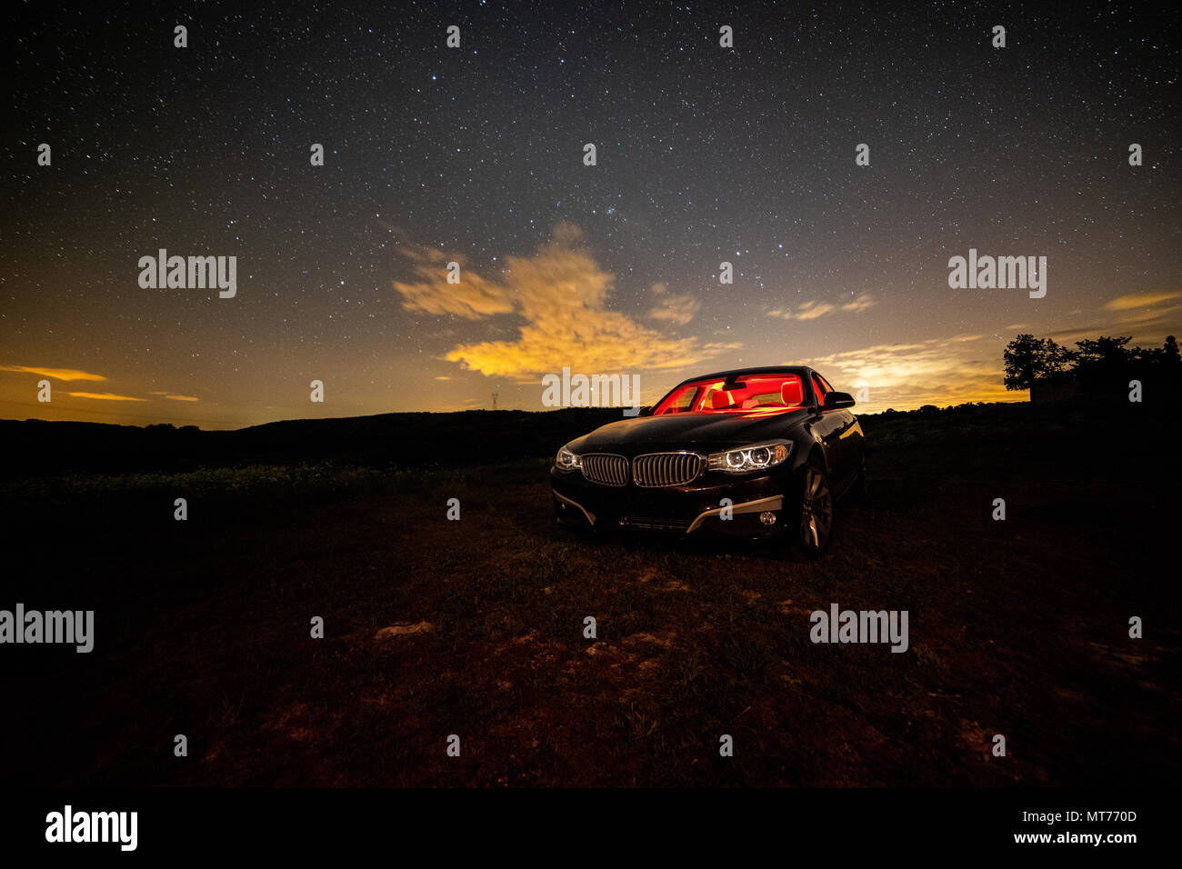 Long Night Photography Of A Car With Red Color Illuminated