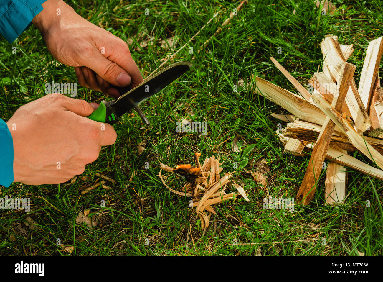 using survival knife with firestarter Stock Photo Alamy