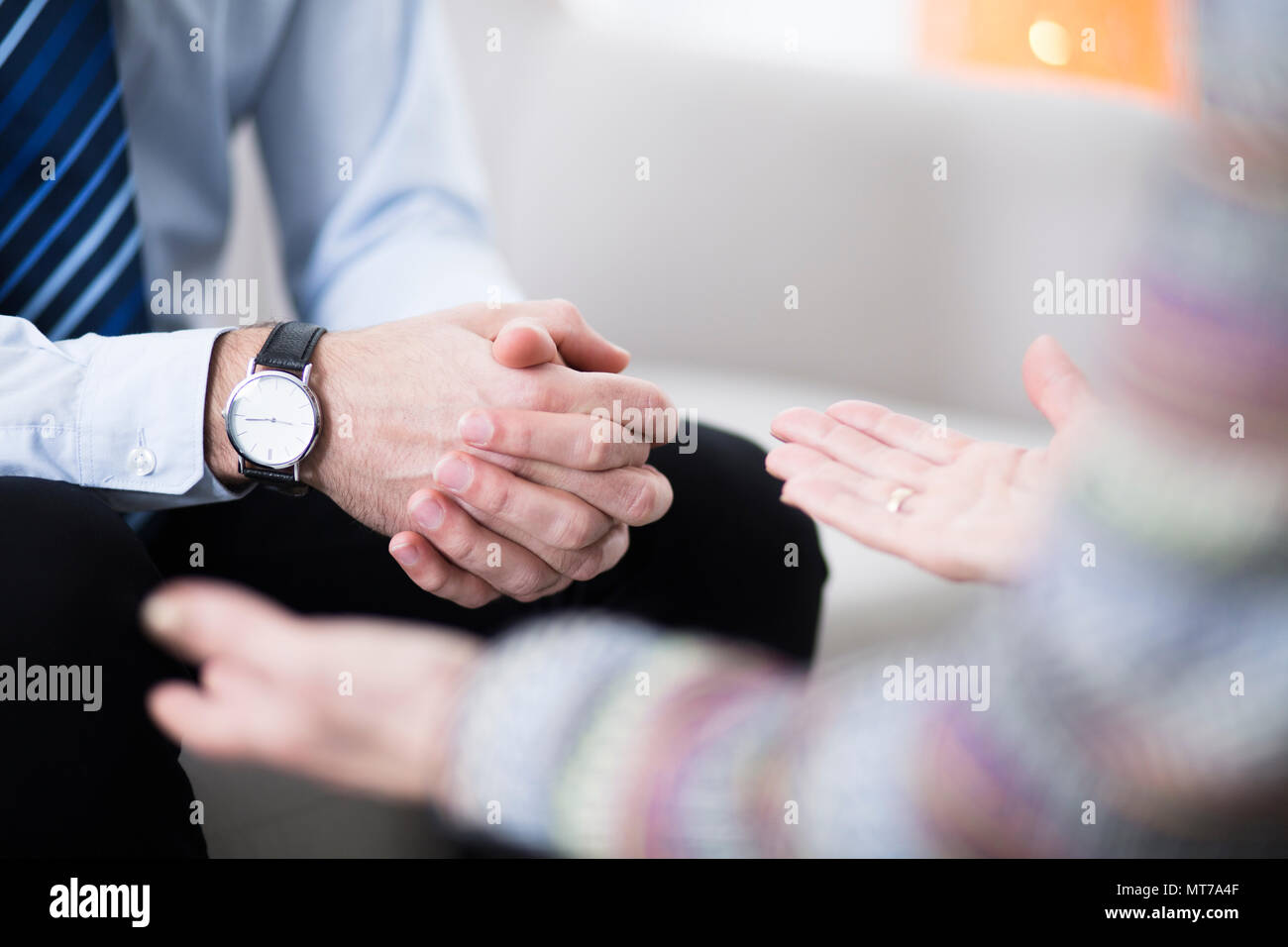 Close-up of male hands with an elegant watch and his female therapist's hands Stock Photo