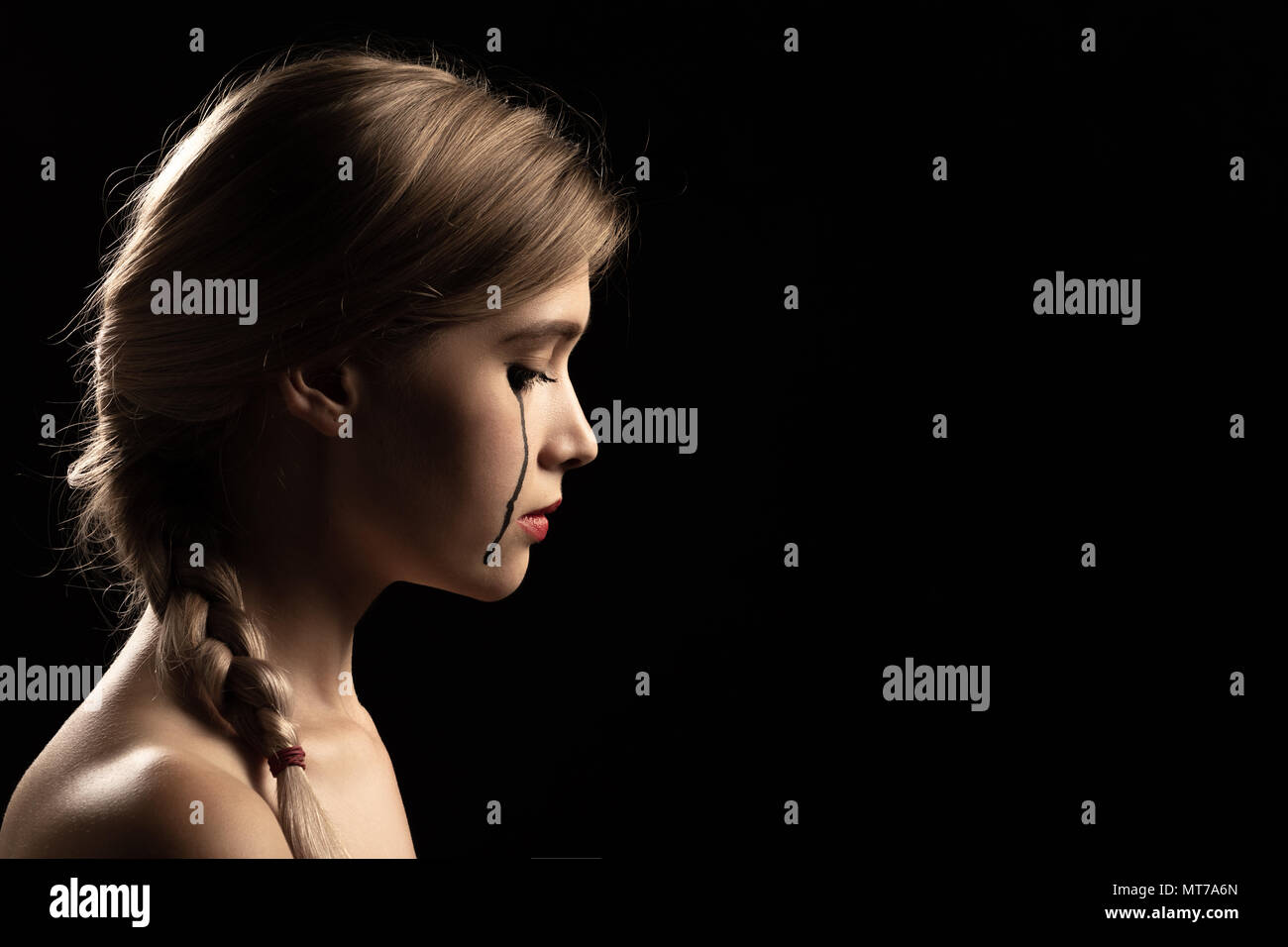 sad woman crying, looking aside on black background, closeup portrait,  profile view Stock Photo - Alamy