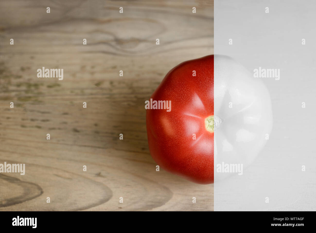 Creative layout made of tomato on wood backgruond. White paint and natural. Food concept. Stock Photo