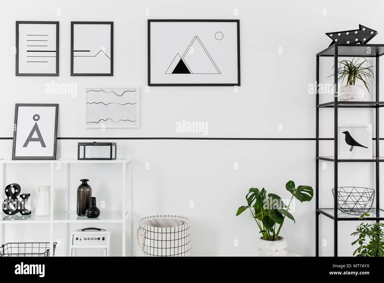 Simple black and white posters hanging on white wall in Nordic style