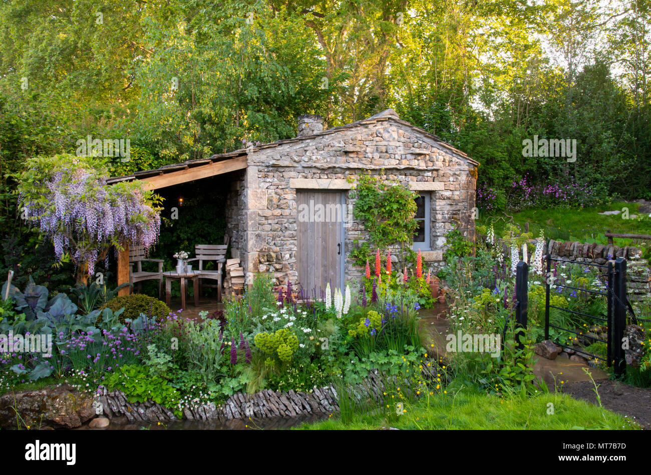 a cottage garden surrounding a stone bothy in the welcome to