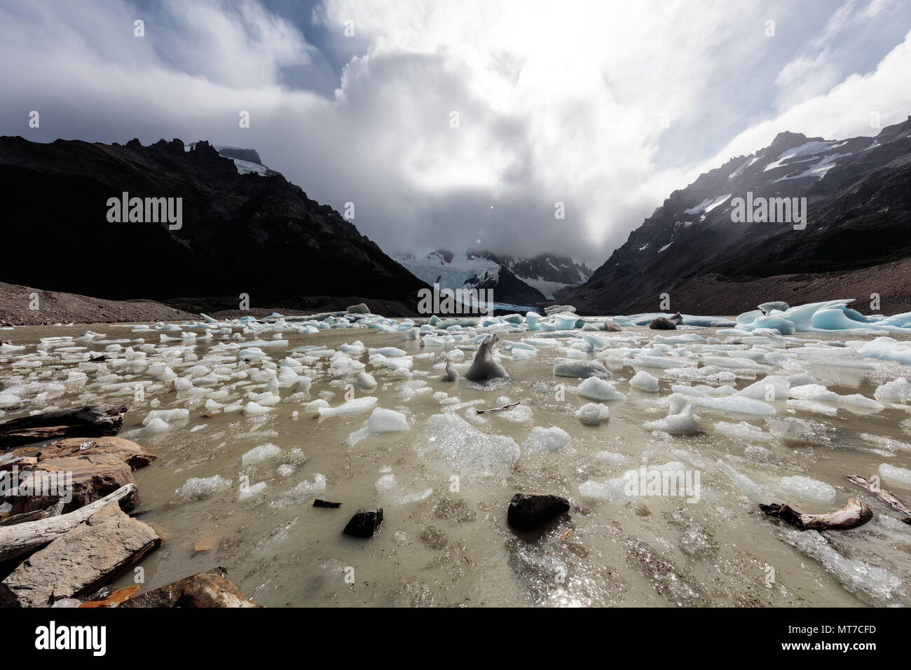 Small blocks of ice dot the shore of a glacial lake at Fitzroy in Argentina Stock Photo