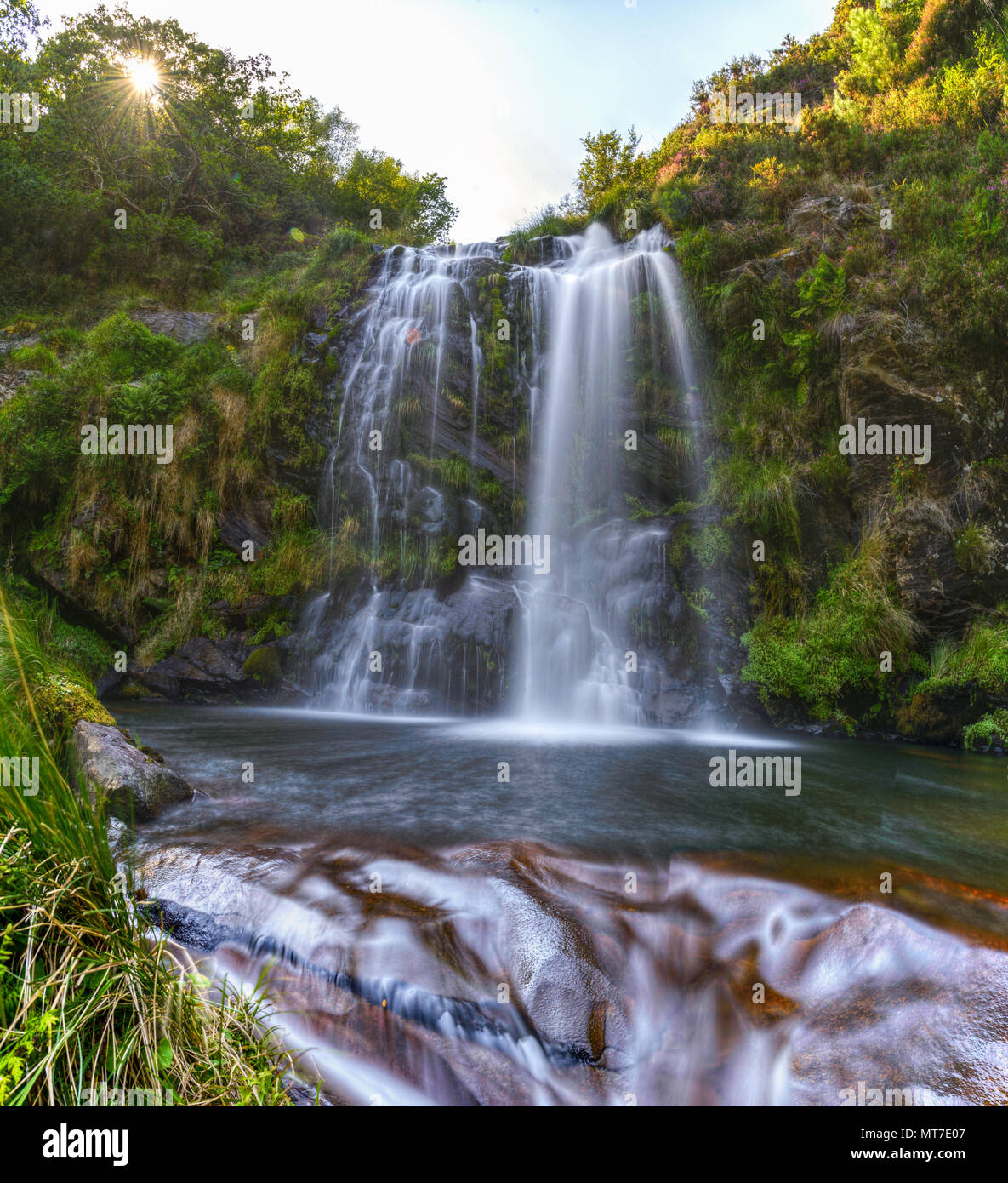 Water flows over the rocks under a waterfall in Muras, Galicia Stock Photo