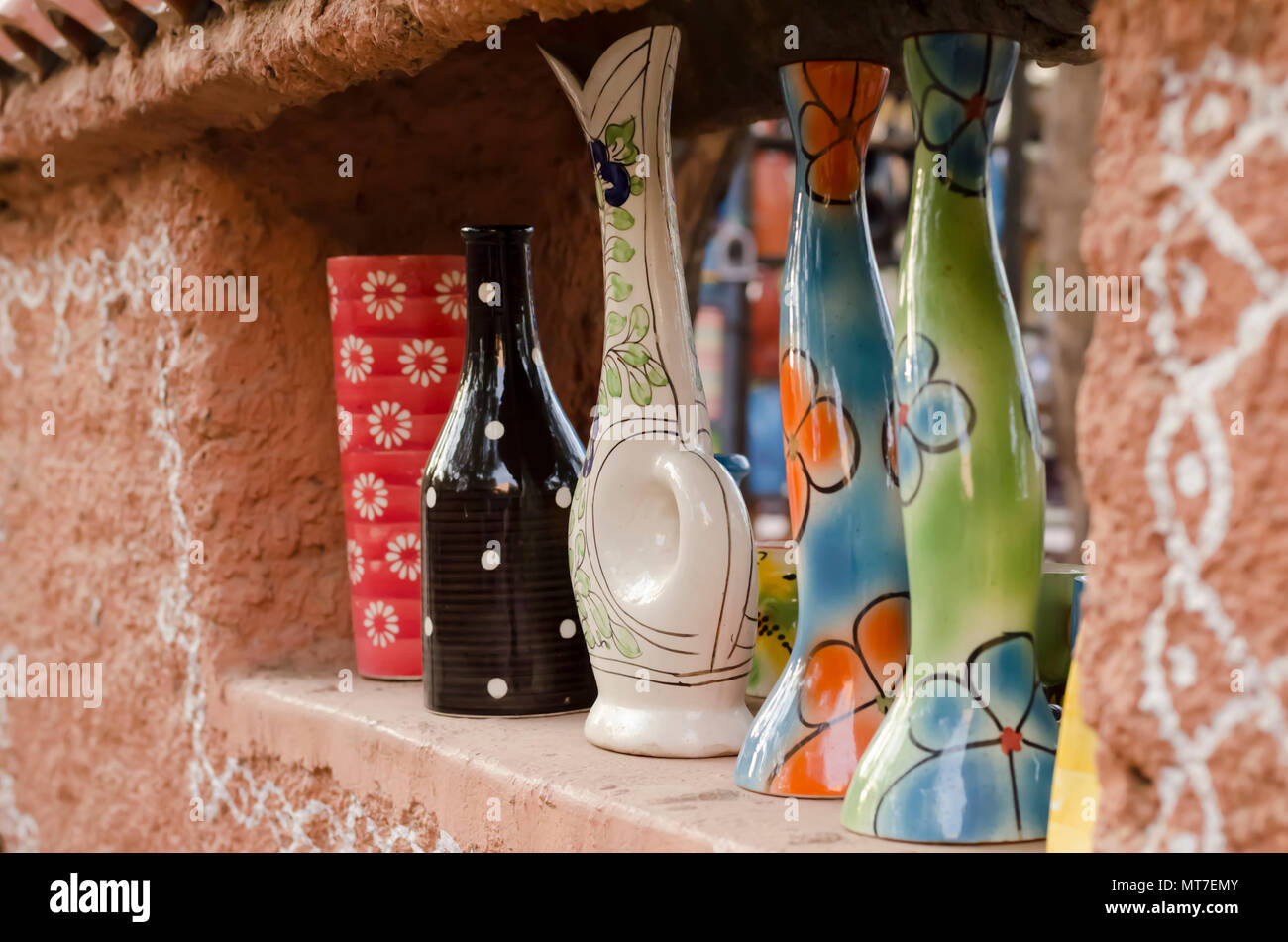 Multicoloured/Multicolored ceramic vases with floral designs on display