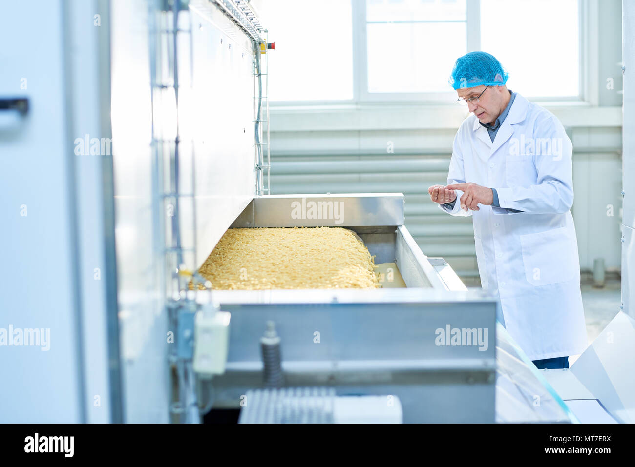 Senior Man Overseeing Production Process Stock Photo - Alamy