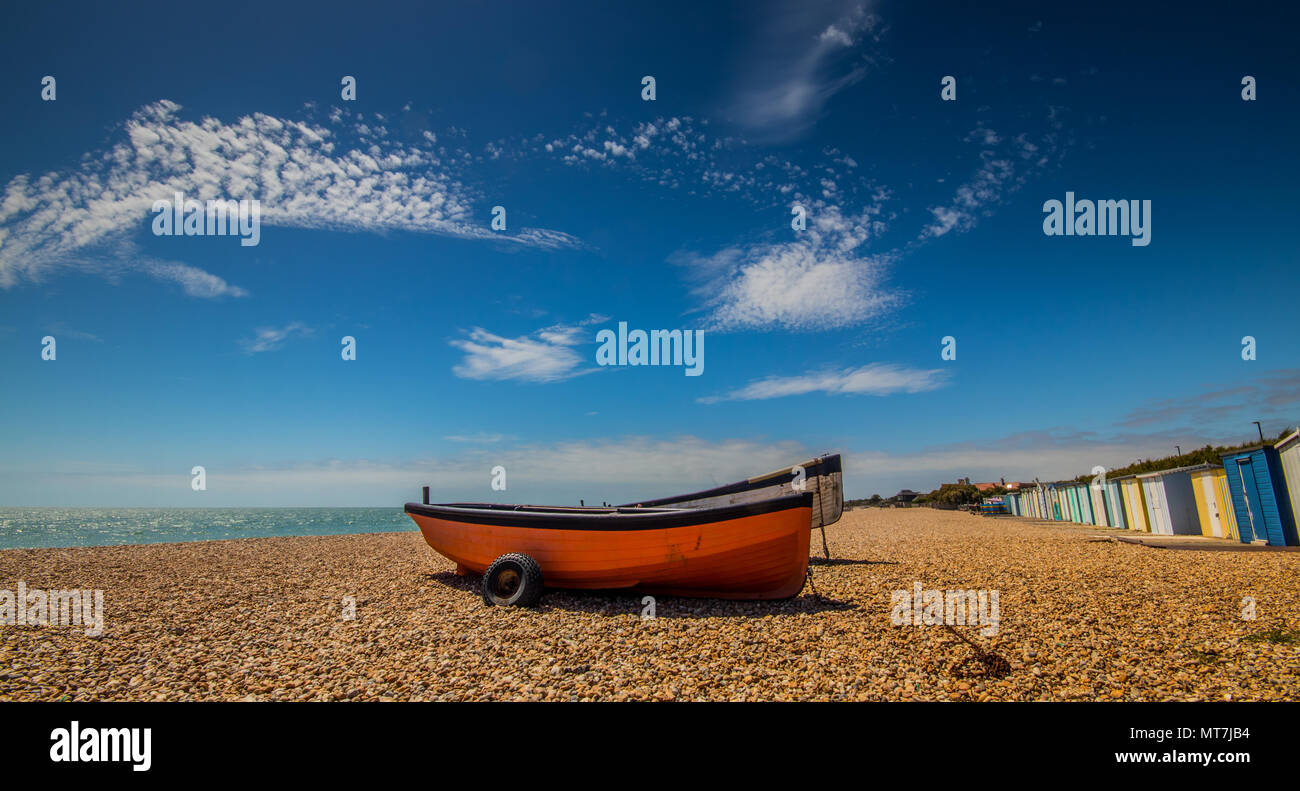 Fishing boats on the shingle beach near the Boat Pound with beach huts