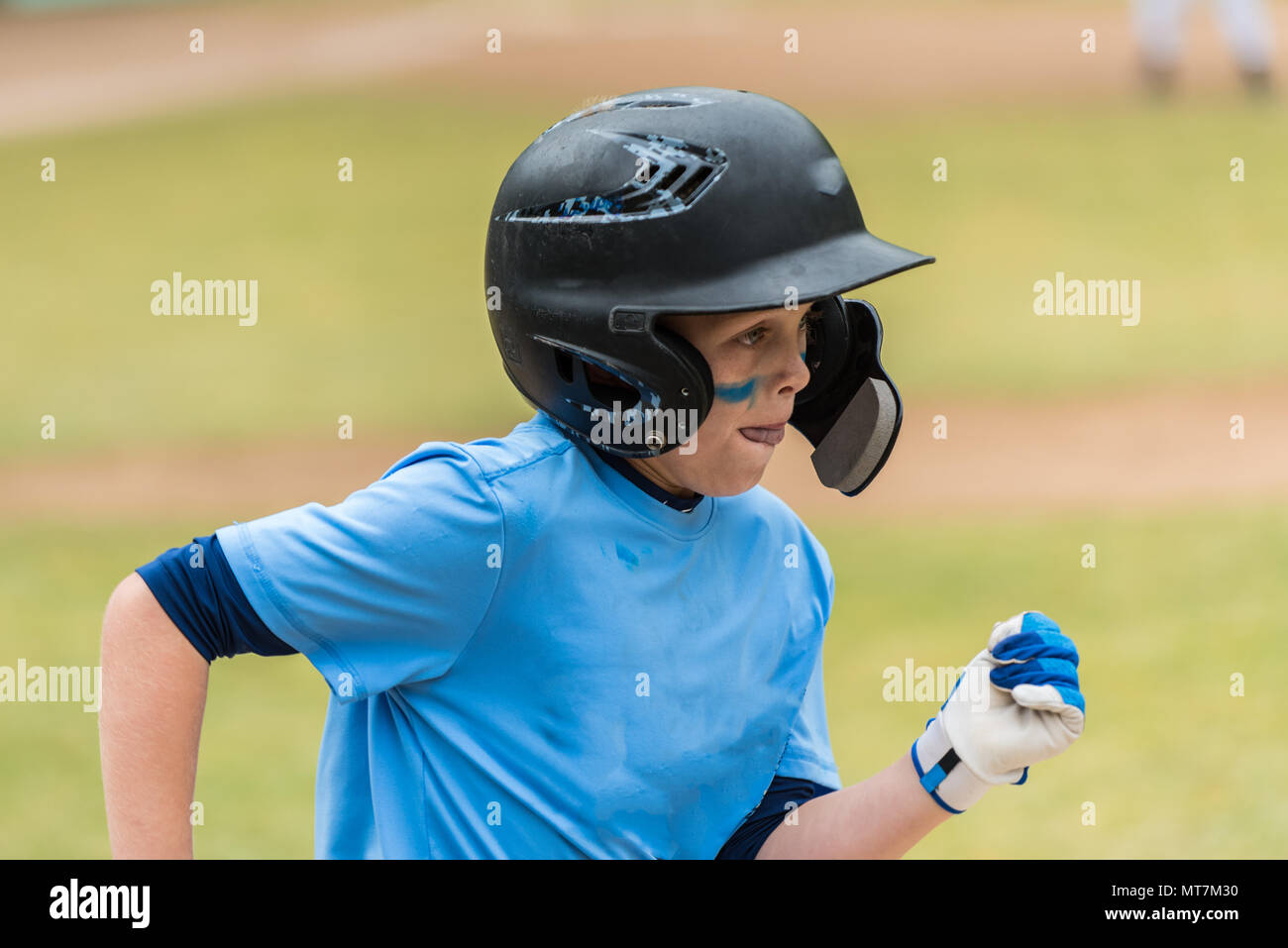 Close up of little league baseball players face showing eye black and